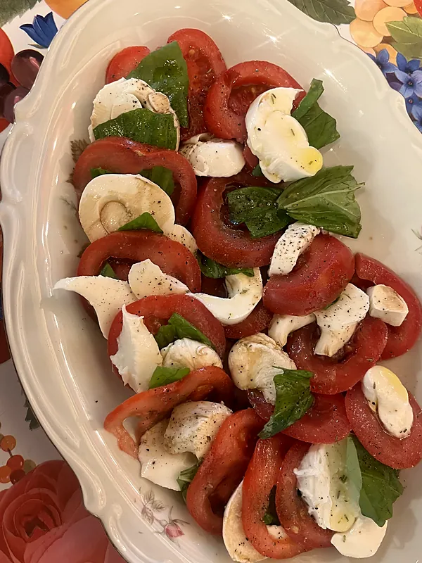 Caprese salad of tomato, mozzarella and basil on a vintage platter